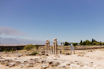 Journey to the old city. Preserved old columns against the backdrop of a mountain landscape....