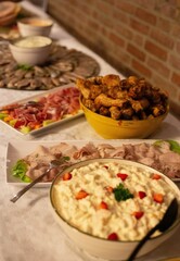 Vertical shot of the delicious-looking dishes and salads with meat and vegetable on the table