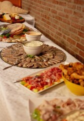Vertical shot of the delicious-looking dishes and salads with meat and vegetable on the table