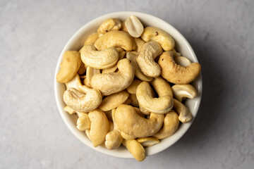 Cashew nuts in a small bowl. Healthy food snack, top view.