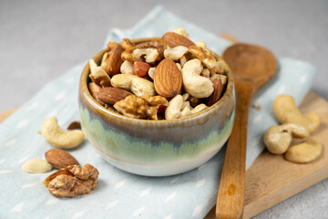 Mix of nuts cashews, almonds, hazelnuts in a small bowl.