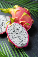 Dragon fruit sliced in halves, exotic dragon fruit over black background