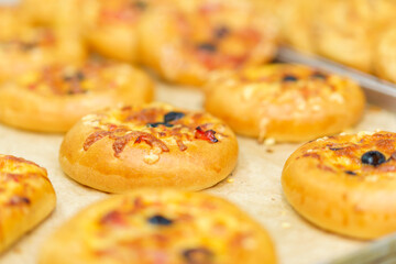 Mini pizza. Appetizing pastries. Fast food. Snack from the bakery for a break. Background with selective focus