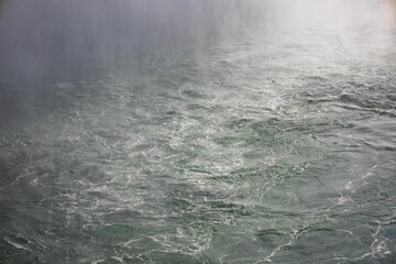 Stunning view of a tranquil body of water sparkling in the sunset light, with waves lapping on shore