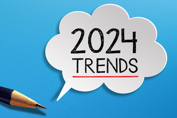 2024 Trends written on speech bubble with pencil on blue background