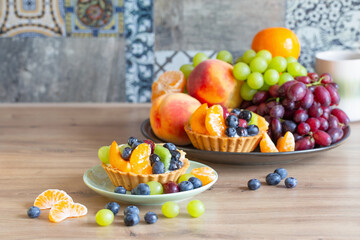 cupcakes with fruits on wooden table on kitchen