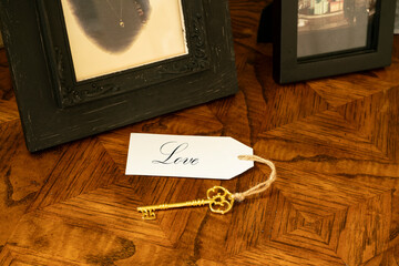 A gold key with tag attached reading love