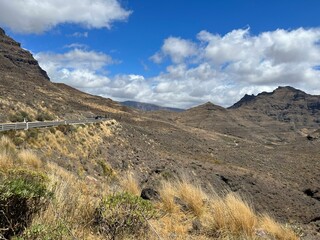 Winding road in a breathtaking mountain landscape with a rocky terrain