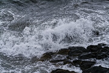 Scenic view of a rocky beach against sea waves