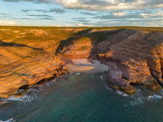 Aerial view of Pot Alley Beach against the sea at golden hour in Kalbarri, Australia