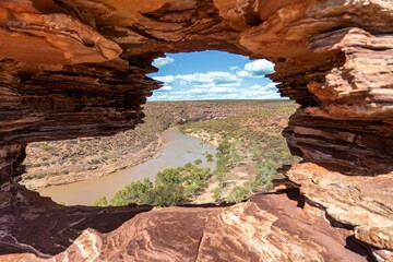 Scenic view of a tranquil river valley, framed by a window in Kalbarri National Park.