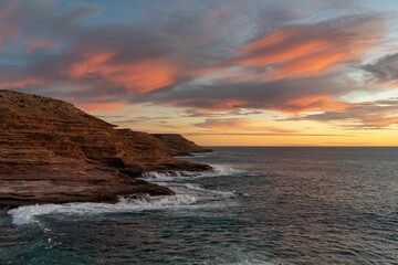 Closeup of a beautiful sunset above a body of tranquil water