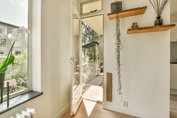 a room with a window and some plants on the ledges in front of the door that leads to an outside patio