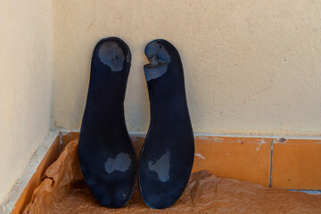 Worn-out shoe insoles on paper, showing the hopeless situation of refugees trying to illegally...