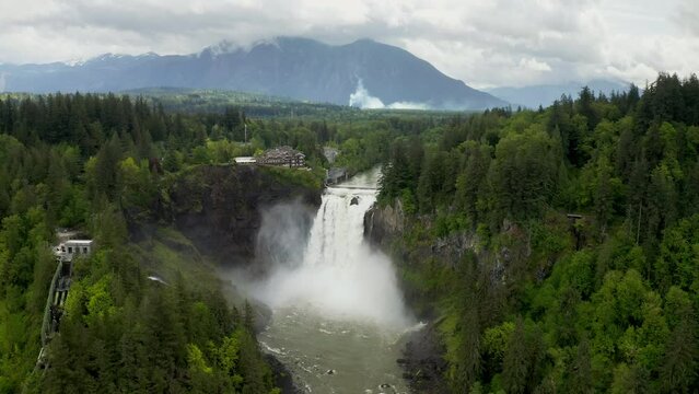 Drone Footage of Snoqualmie Falls with Mountains in the background