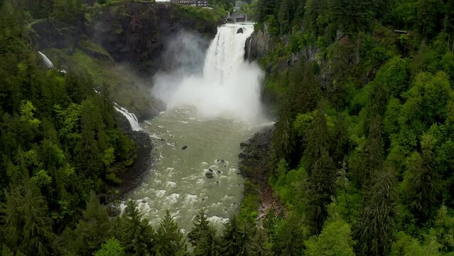Aerial Footage of Snoqualmie Falls with Mountains in the background