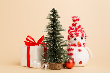 Miniature christmas tree with gift boxes and decor on table