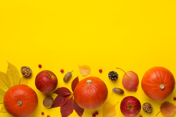 Flat lay with pumpkins, fruits and autumn leaves on color background, top view