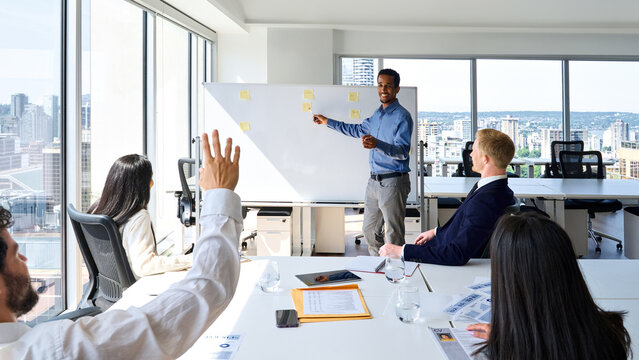 African Business Man Presenter Team Leader Giving Presentation Training On Whiteboard In Office. Male Company Executive Manager Presenting Corporate Strategy At Group Conference Meeting.