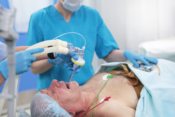 Tracheal intubation.An elderly man before surgery. Preparation for anesthesia. Introduction of...