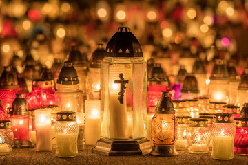 Candle lights at the cemetery at night in Poland during All Saints Day
