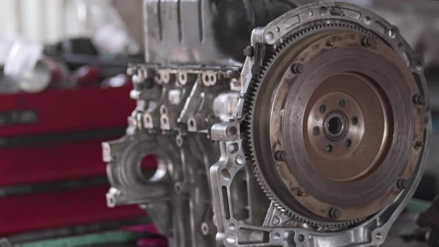 Master Repairing Flywheel Gear Of Car Engine In Repair Shop Footage.