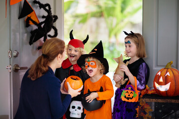 Kids trick or treat. Halloween. Child at door.