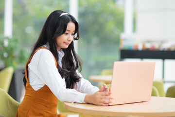Beautiful Asian teenager girl with laptop.