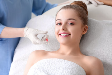 Fototapeta na wymiar Young woman undergoing treatment in beauty salon. Skin care concept