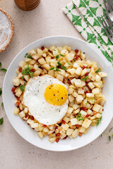 Potato hash with pancetta topped with a fried egg