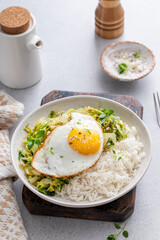 Rice bowl with sauteed cabbage and fried egg, healthy lunch or breakfast idea