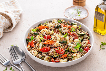Warm quinoa salad with roasted vegetables and fresh tomatoes