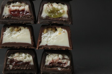 Assorted set of chocolate case candies with vanilla praline filling and jelly berry cherry lemon...