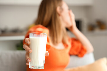 Young woman with lactose intolerance at home