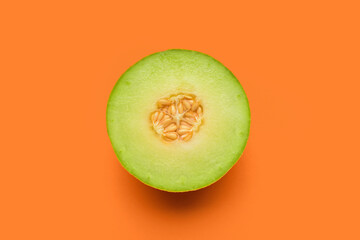 Half of tasty ripe melon on orange background - obrazy, fototapety, plakaty