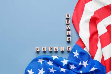 Fototapeta na wymiar Wooden blocks with inscription in memory of National Day of Prayer and Remembrance for the Victims of the Terrorist Attacks on grey background