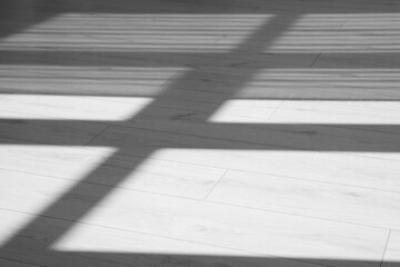 Shadow from window on white laminated floor