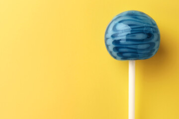 Tasty lollipop on orange background, top view. Space for text