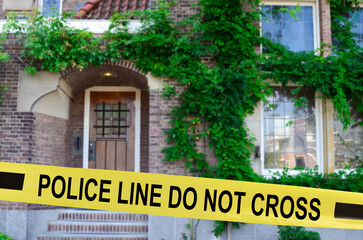 Fototapeta na wymiar Yellow crime scene tape blocking way to house outdoors