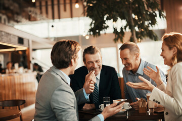 Group of business people having coffee and talking in a cafe decorated for the christmas and new...