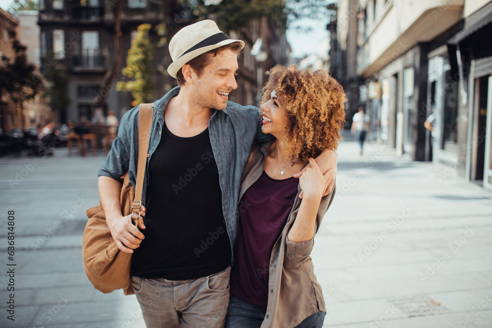 Wall mural young mixed couple walking and exploring the city