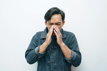 Portrait of Indonesian Asian man sneezing gesture. Unhealthy sick concept isolated white background