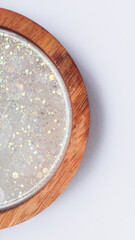 Handmade resin coaster with floral pattern on white background. Selective focus.