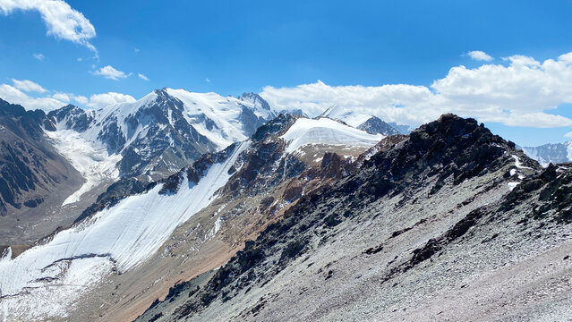 Snow-capped mountain peaks. Beautiful mountain summer landscape. Amazing mountain view around Komsomolets Peak, Ala-Archa National Park, Kyrgyzstan. 