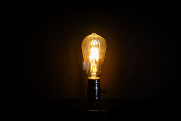 Light bulb for power and idea concept. retro bulb on black background.
