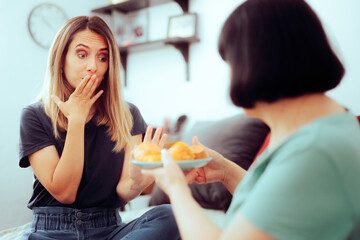 Guest Feeling Sick Unable to Eat More of the Treats. Girl refusing pastry suffering from celiac disease 

