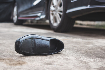 Close-up of shoe  on a road after a collision with a car - obrazy, fototapety, plakaty