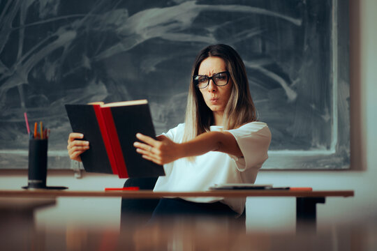 Teacher Wearing Reading Glasses Suffering from Presbyopia. Professor fact checking textbook misinformation mistake
