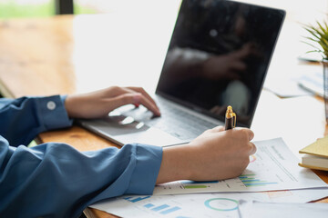 Asian business team consists of marketing staff. accountant and financial officer Help each other analyze company profits using tablets. calculator Laptop computers, graph paper, and corporate pens.
