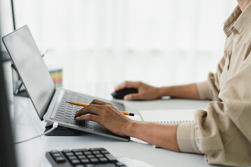 Developer programmer using mouse and typing code on laptop while programming to developing website